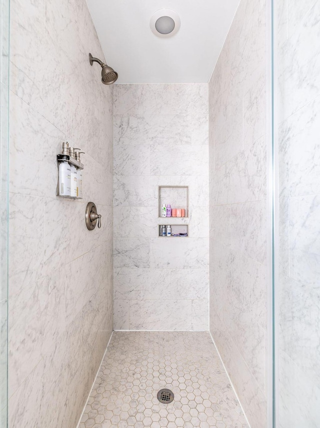 bathroom with a tile shower