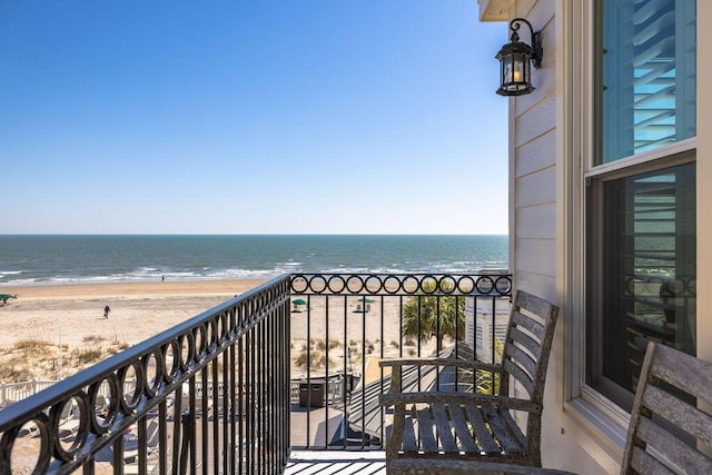 balcony featuring a beach view and a water view