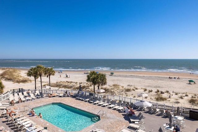 exterior space featuring fence and a beach view