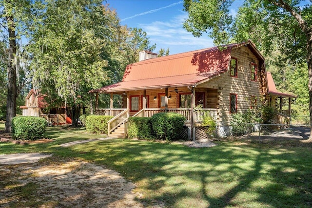 back of house featuring covered porch and a yard