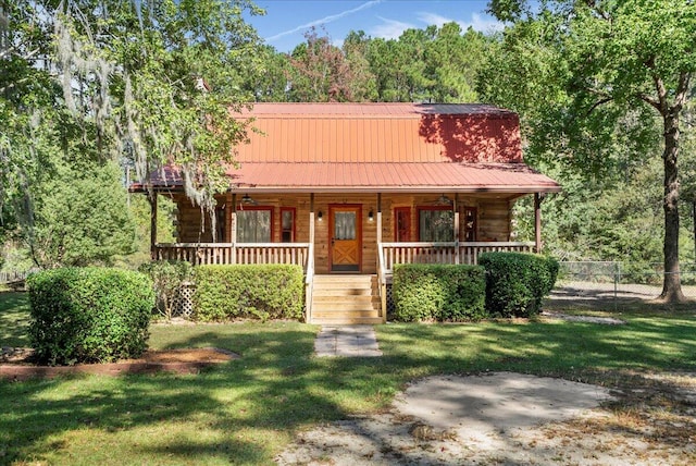 log home featuring a front yard and covered porch