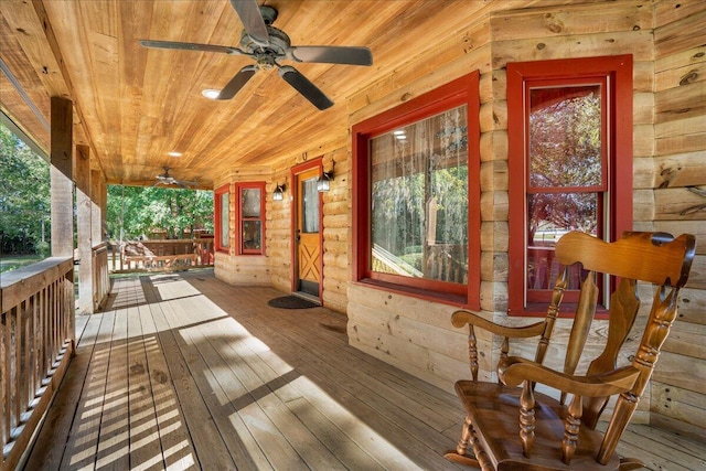 wooden terrace with covered porch and ceiling fan