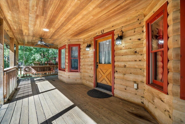 wooden deck with a porch and ceiling fan