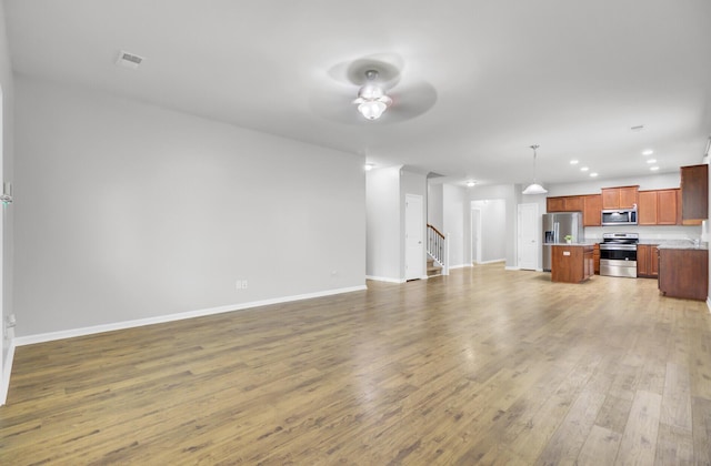 121 Ancestry Ln, Moncks Corner, SC 29461 - unfurnished living room featuring light wood-style floors, baseboards, stairs, ceiling fan, and recessed lighting