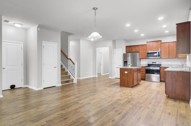 121 Ancestry Ln, Moncks Corner, SC 29461 - kitchen with stainless steel appliances, a kitchen island, light wood-style floors, baseboards, and recessed lighting