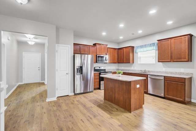 121 Ancestry Ln, Moncks Corner, SC 29461 - kitchen with appliances with stainless steel finishes, a sink, light wood-style flooring, a kitchen island, and recessed lighting