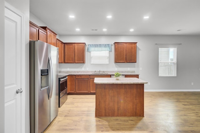 121 Ancestry Ln, Moncks Corner, SC 29461 - kitchen featuring appliances with stainless steel finishes, a kitchen island, light wood-style floors, recessed lighting, and a sink