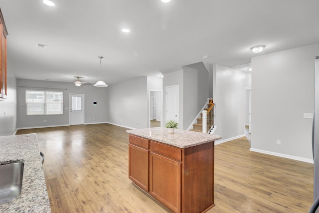 121 Ancestry Ln, Moncks Corner, SC 29461 - kitchen featuring open floor plan, light wood-type flooring, baseboards, light stone countertops, and recessed lighting