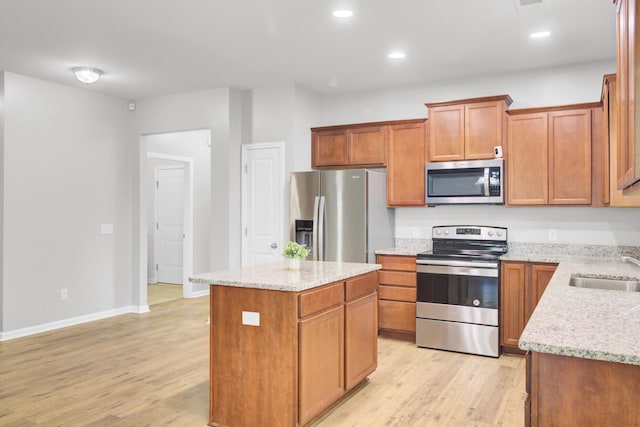 121 Ancestry Ln, Moncks Corner, SC 29461 - kitchen featuring appliances with stainless steel finishes, light wood-style floors, a center island, light stone counters, and recessed lighting