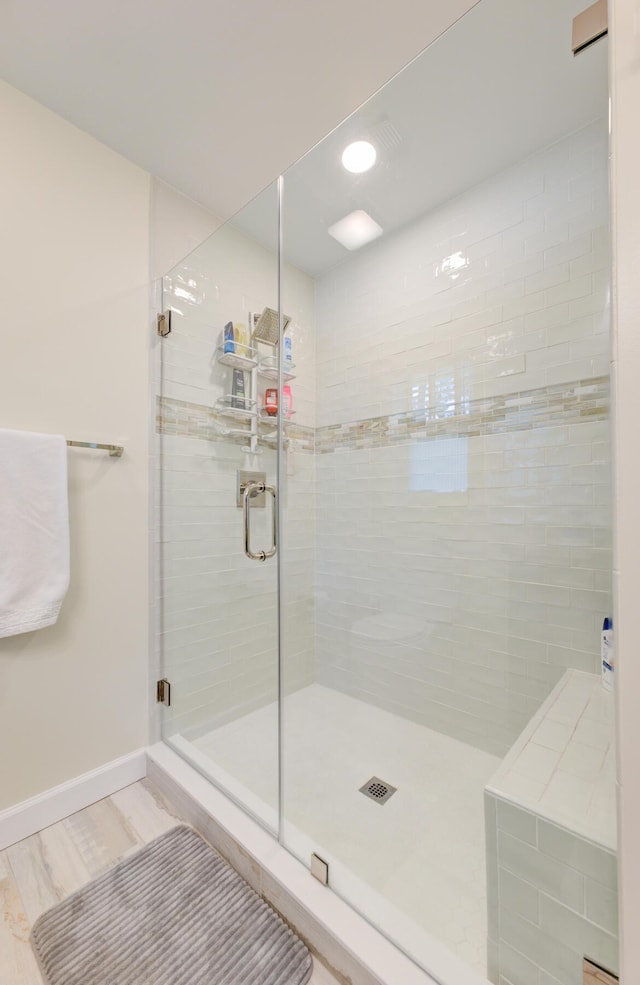 bathroom with an enclosed shower and hardwood / wood-style flooring