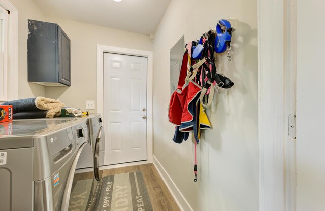 washroom featuring hardwood / wood-style floors, cabinets, and independent washer and dryer