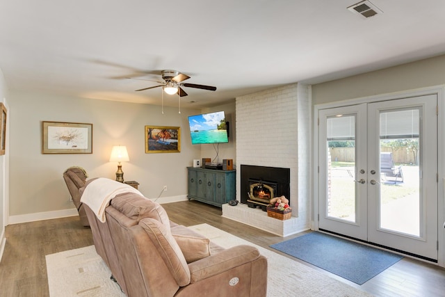 living room with ceiling fan, french doors, and wood-type flooring