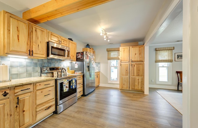 kitchen with decorative backsplash, light brown cabinets, plenty of natural light, and appliances with stainless steel finishes