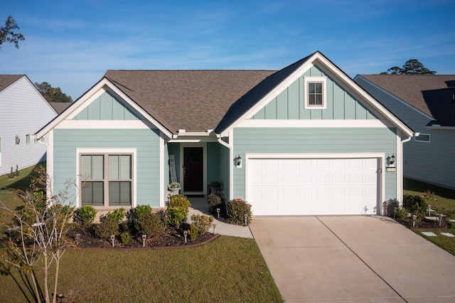 view of front of property featuring a garage and a front lawn