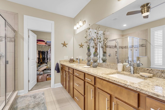 bathroom with tile patterned floors, ceiling fan, vanity, and walk in shower