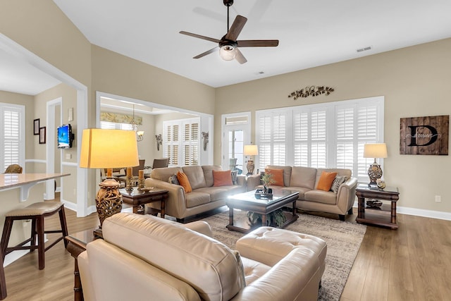 living room with hardwood / wood-style floors and ceiling fan