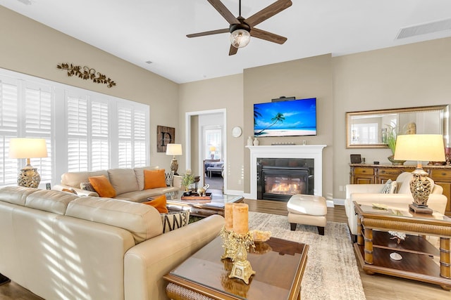 living room featuring ceiling fan and light hardwood / wood-style flooring