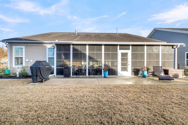 back of house with a sunroom, a yard, and a patio