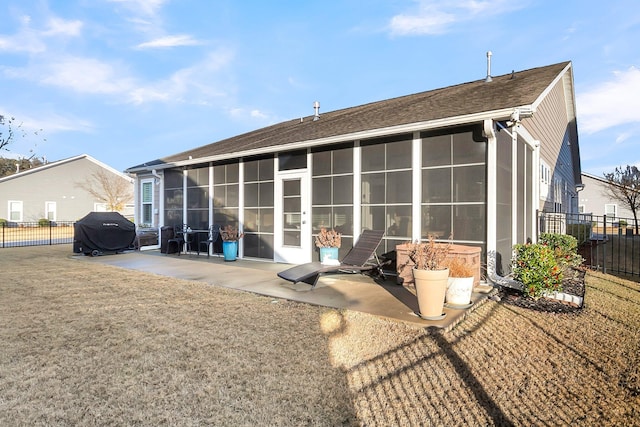 back of house with a patio area and a sunroom