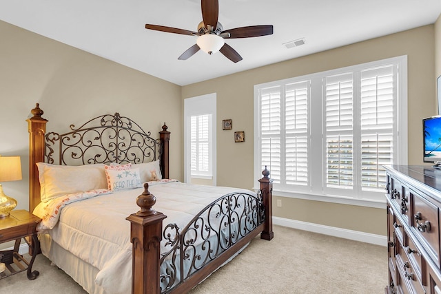 bedroom with ceiling fan and light carpet