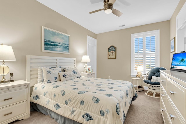 bedroom with ceiling fan and light carpet