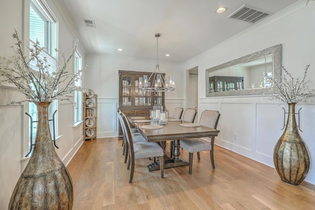 dining space featuring ornamental molding and hardwood / wood-style floors