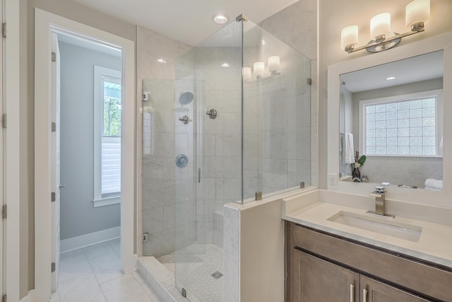 bathroom with tile patterned flooring, a shower with shower door, and a healthy amount of sunlight