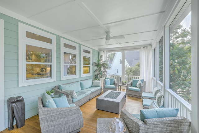 sunroom / solarium with ceiling fan and coffered ceiling