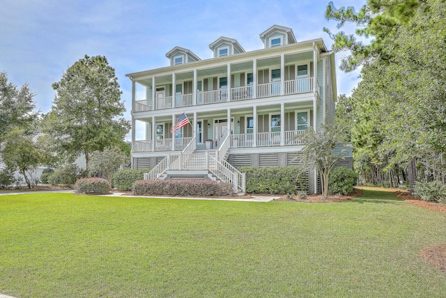 view of front of house with covered porch and a front lawn