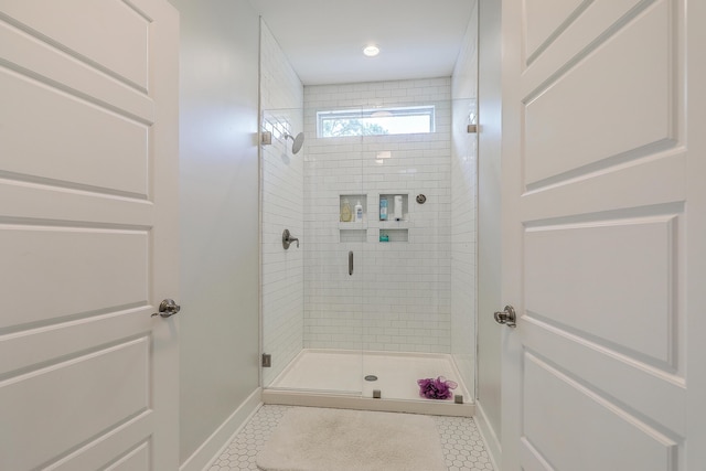 bathroom with tile patterned flooring and a shower with shower door