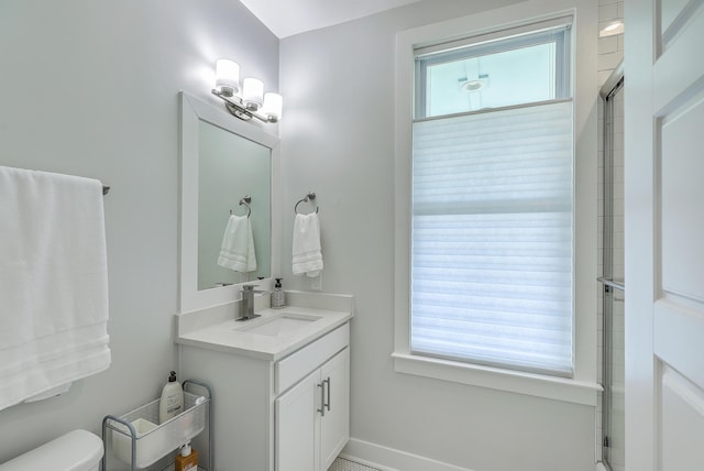 bathroom featuring toilet, walk in shower, and vanity