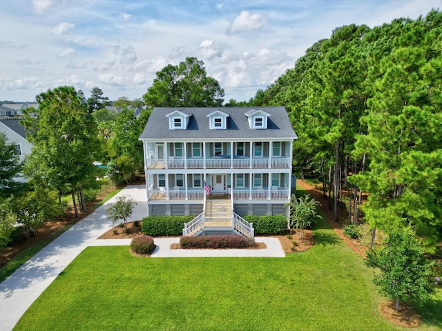 view of front of house featuring covered porch and a front yard