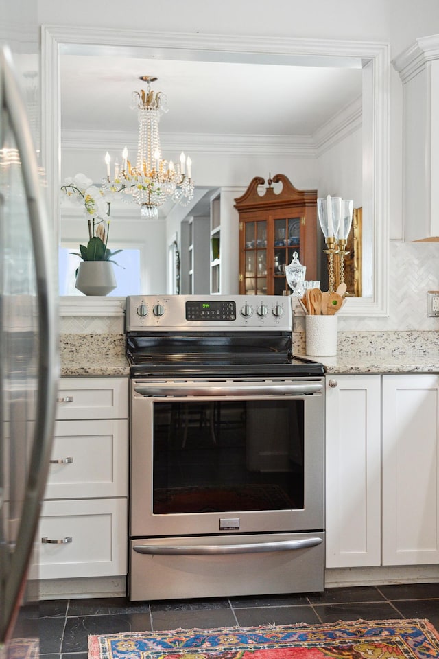 kitchen with ornamental molding, white cabinetry, light stone countertops, and stainless steel appliances