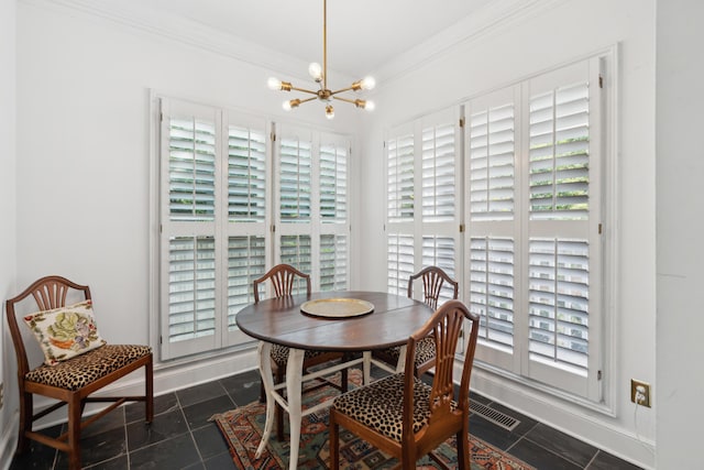 dining space with plenty of natural light, dark tile patterned floors, ornamental molding, and a notable chandelier