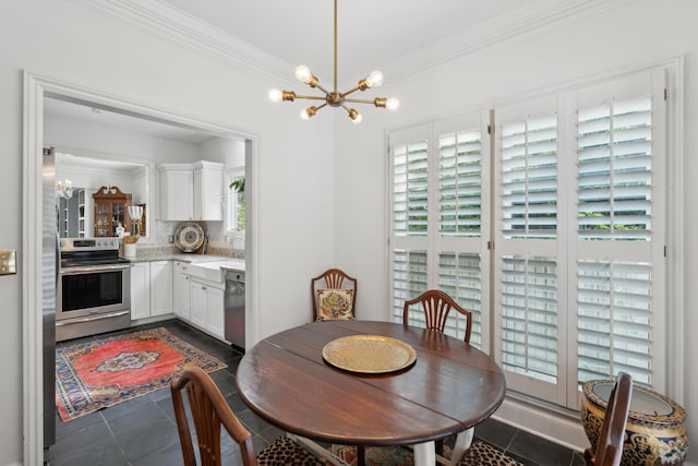 dining room with an inviting chandelier, ornamental molding, and dark tile patterned flooring