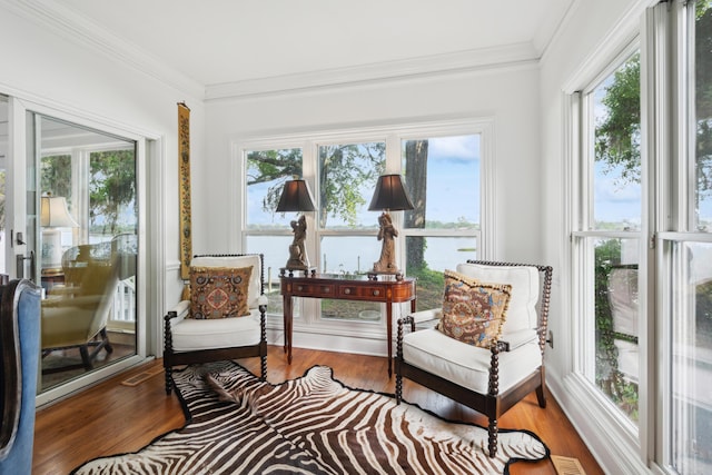 sunroom / solarium with ornamental molding and a healthy amount of sunlight