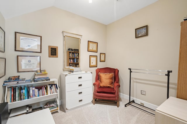 sitting room featuring carpet floors, baseboards, and vaulted ceiling