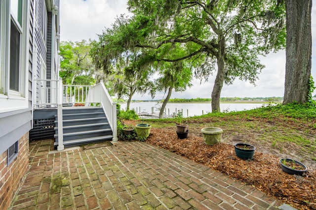 view of patio with a water view