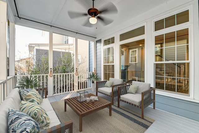 sunroom / solarium with a ceiling fan