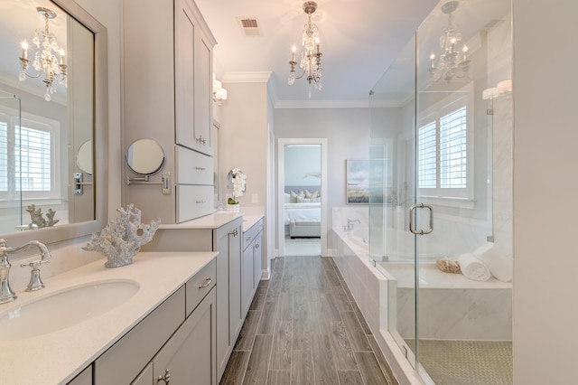 bathroom featuring visible vents, a notable chandelier, a shower stall, and crown molding