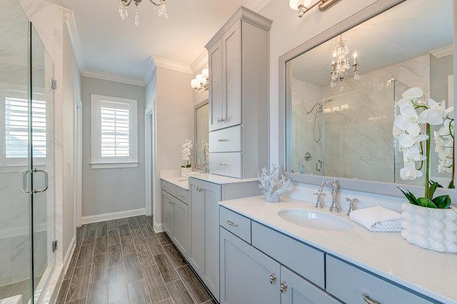 bathroom featuring a notable chandelier, ornamental molding, a marble finish shower, baseboards, and wood tiled floor