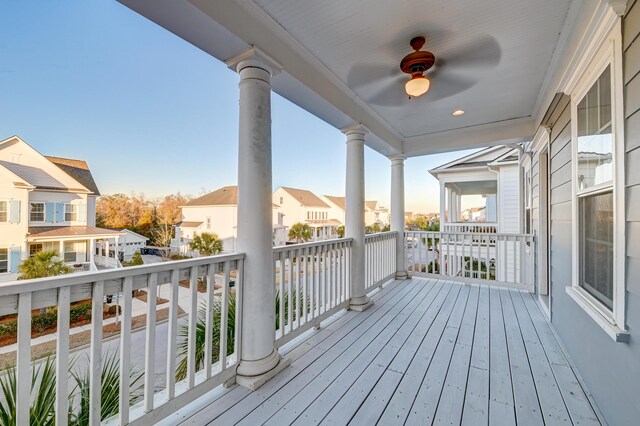 wooden deck featuring a residential view and ceiling fan