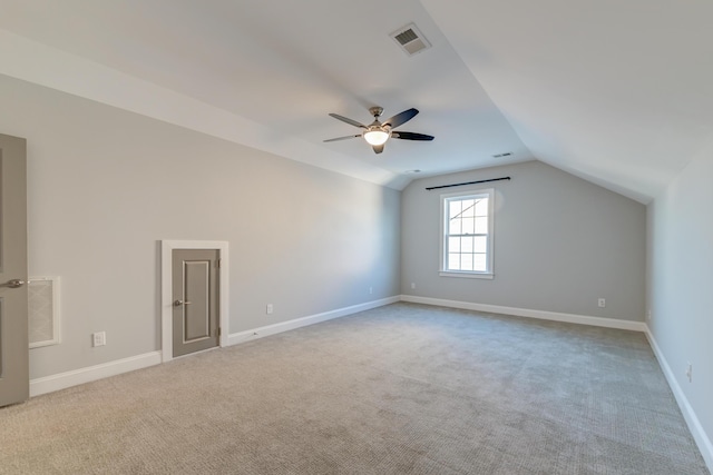 bonus room featuring lofted ceiling, carpet flooring, baseboards, and visible vents