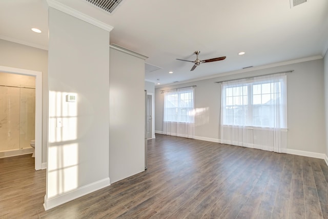 spare room with wood finished floors and ornamental molding