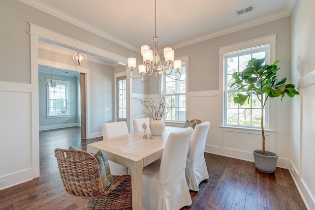 dining space featuring dark wood-type flooring, plenty of natural light, and visible vents