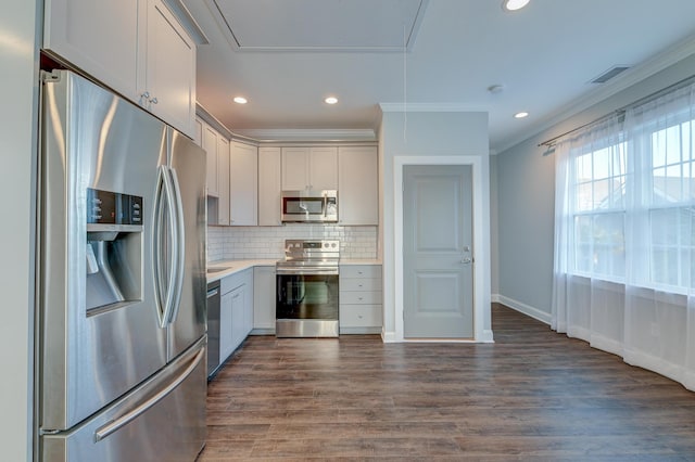 kitchen with visible vents, dark wood-style flooring, light countertops, appliances with stainless steel finishes, and tasteful backsplash