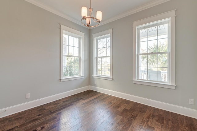 unfurnished room with dark wood finished floors, a notable chandelier, baseboards, and ornamental molding