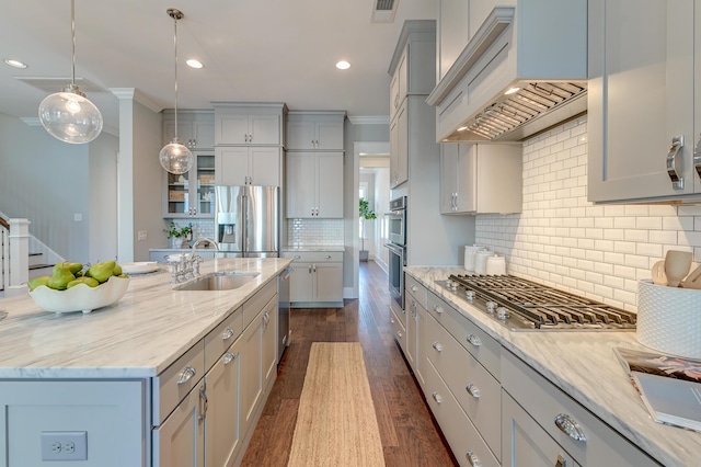 kitchen with premium range hood, visible vents, a sink, dark wood-style floors, and appliances with stainless steel finishes