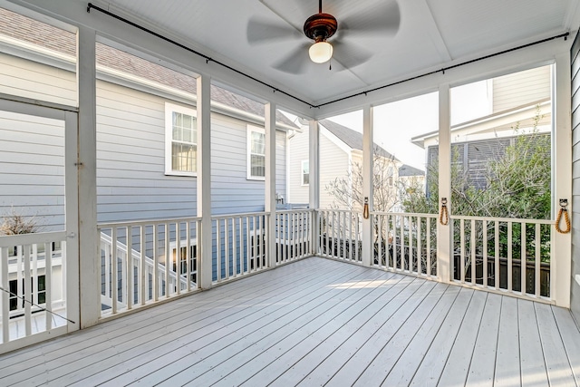 unfurnished sunroom with a ceiling fan