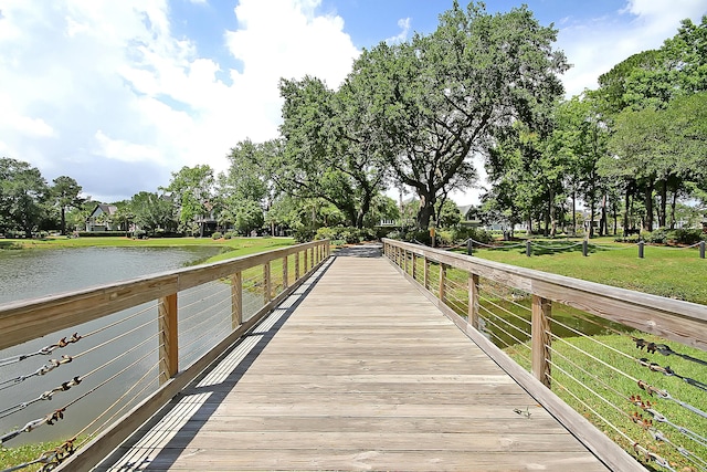 dock area featuring a water view and a lawn